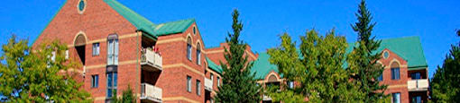 Testa Heights Apartments in Uxbridge, ON Side of Building show casing landscaping and large trees on property grounds