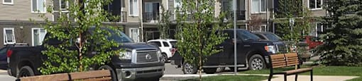 Airdrie Place in Airdrie, AB Building exterior highlighting modern design and parking lot