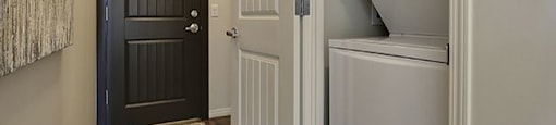 Airdrie Place in Airdrie, AB Washer/dryer in efficient closet in main hallway