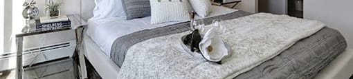 Airdrie Place in Airdrie, AB Elegant bedroom with walk-in closet and bathroom