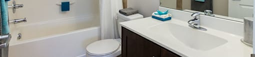 Beacon Heights in Calgary, AB bathroom with large mirror and full sized bathroom