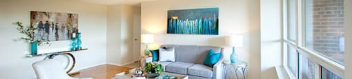 Brookbanks Apartments living room with hardwood flooring and large windows in Toronto, ON