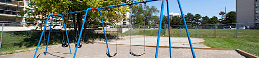 Rockford Apartments playground with swings in Toronto, ON