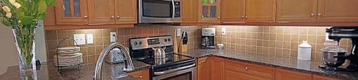 The Conservatory spacious kitchen with stainless steel appliances in Kelowna, BC