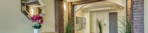 Citadel in North Vancouver, BC Apartment hallway with hardwood floors and brick archways