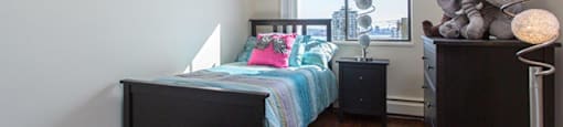 Shoreview in North Vancouver, BC Bedroom with unique round lamp and bed with teal covers