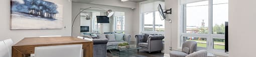 Spacious social room with seating and TV at Axial Towers