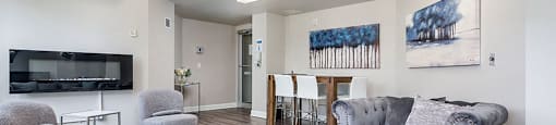 Social room with fireplace and dining table at Axial Towers
