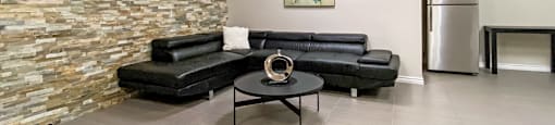 a social room with a couch and a table at Rittenhouse Apartments in Kitchener Ontario