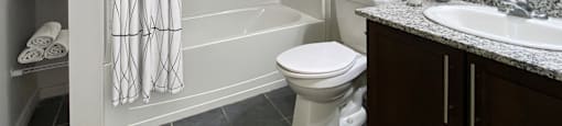 a bathroom with a shower toilet and sink at Rittenhouse Apartments in Kitchener Ontario