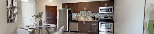 a living room with a couch and a table and a kitchen at Rittenhouse Apartments in Kitchener Ontario