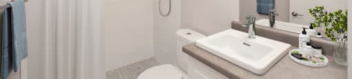 Bathroom with walk-in shower, toilet and vanity with top-mount sink at Riverbend Tower Apartments in Chatham, ON