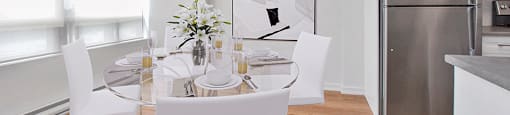Dining area with large window and table and chairs