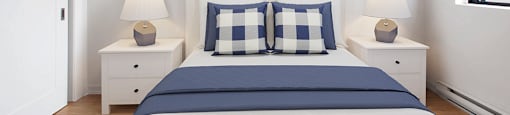 Primary bedroom with queen size bed at Riverbend Tower Apartments in Chatham, ON