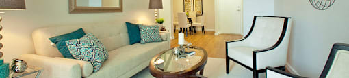 Lord Simcoe Apartments modern living room with view into dining area in Niagara Falls, ON