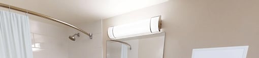 bathroom with a tub-shower combo, vanity with drawer and cupboard storage in a renovated 3 bed 2 bath suite at Somerset Place in London, ON.