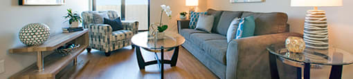Shannon Towers in Collingwood, ON spacious living room with hard surface flooring and balcony access