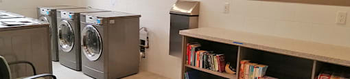 Silvercreek Towers in Georgetown, ON laundry facility with book shelf and TV