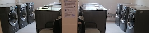 a row of washing machines in a laundromat