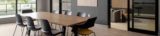 A conference room with a long table and chairs at The Ambrosi in Kelowna, BC.