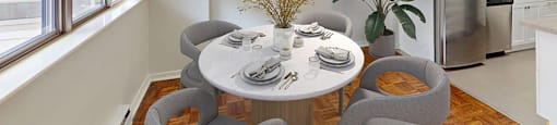A dining room with a table set for four in a renovated 2 bed 1.5 bath suite at Somerset Place in London, ON.