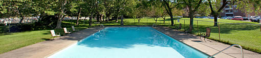 St. Lawrence Village in St. Catharines, ON Outdoor pool surrounded by lush trees