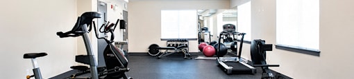 Summerhill Place in Nanaimo, BC gym with cardio machines and weights