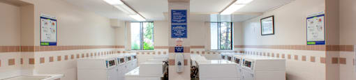 Sunnidale Place in Barrie, ON shared laundry space with several washing machines and dryers
