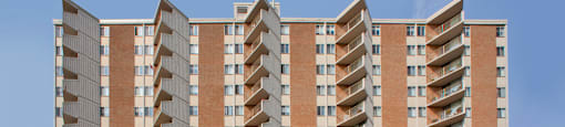 Sunset Towers building exterior showing straight on view with balconies and driveway in St. Thomas, ON