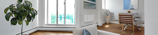 Sunset Towers living and dining room looking towards balcony with sliding glass door in St. Thomas, ON