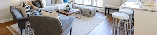 a living room with a couch and a bar Surrey Village Apartments in Surrey BC