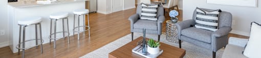 a living room and kitchen with a dining area and a bar at Surrey Village in Surrey BC