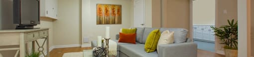 Tamarack Woods Cozy open concept basement with a soft white rug, a tv, and a couch in Barrie, ON