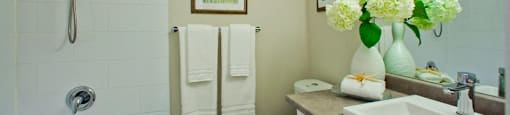 Tamarack Woods Classic full bathroom with bathtub and matching blue and green paintings in Barrie, ON