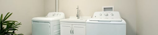 Tamarack Woods Private laundry room with spotless walls, a washer, dryer and sink in Barrie, ON