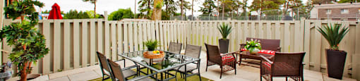 Tamarack Woods Spacious patio space with perfect white fence and a seating area in the center in Barrie, ON