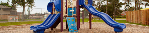 Tamarack Woods playground, showing play structure with slides and climbing wall in Barrie, ON