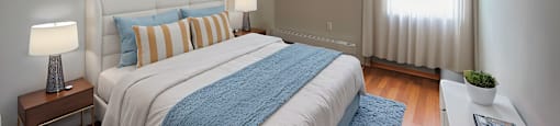 A bedroom with a large bed and a window in Peterborough ON