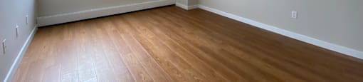 Primary bedroom in a two bedroom suite looking towards sliding glass window at Tarawood Place in Peterborough, ON
