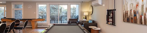 a pool table in the center of a living room with a billiards room