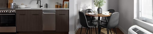 A modern kitchen with a dining table set for two at The Ambrosi in Kelowna, BC.