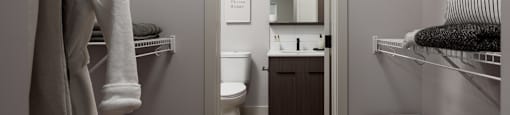 A small, white bathroom with a towel rack and a toilet at The Ambrosi in Kelowna, BC.