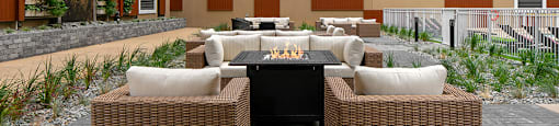 The Conservatory courtyard patio with patio furniture and firepits in Kelowna, BC