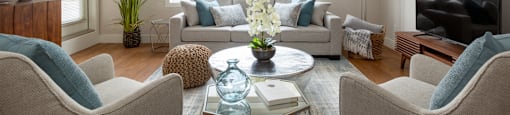 The Conservatory large, elegant living room with big window and hardwood flooring in Kelowna, BC