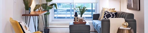 The Miltonian Apartments living area featuring brightly lit windows in Milton, ON