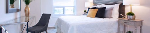 The Miltonian Apartments primary bedroom featuring work station in MIlton, ON