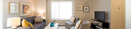 Towns on the Ravine Living room with beige walls and dark wood flooring