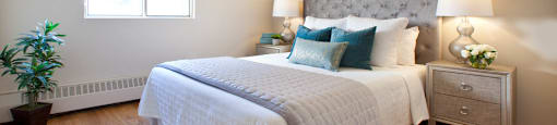 Trillium Apartments  large bedroom with hardwood flooring in Cobourg, ON