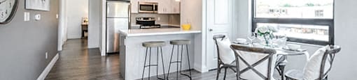 Trio On Belmont dining area with luxury plank flooring and view of kitchen in Kitchener, ON