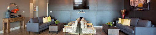 Penthouse resident's lounge with lounge seating and flat screen TV located in Building A at Trio on Belmont in Kitchener, ON